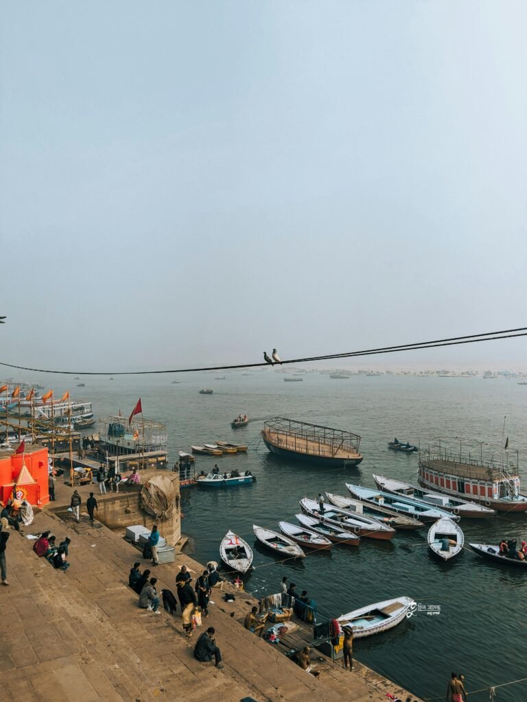 A lively scene of boats and people at the River Ganges in Varanasi, capturing the essence of Indian culture.